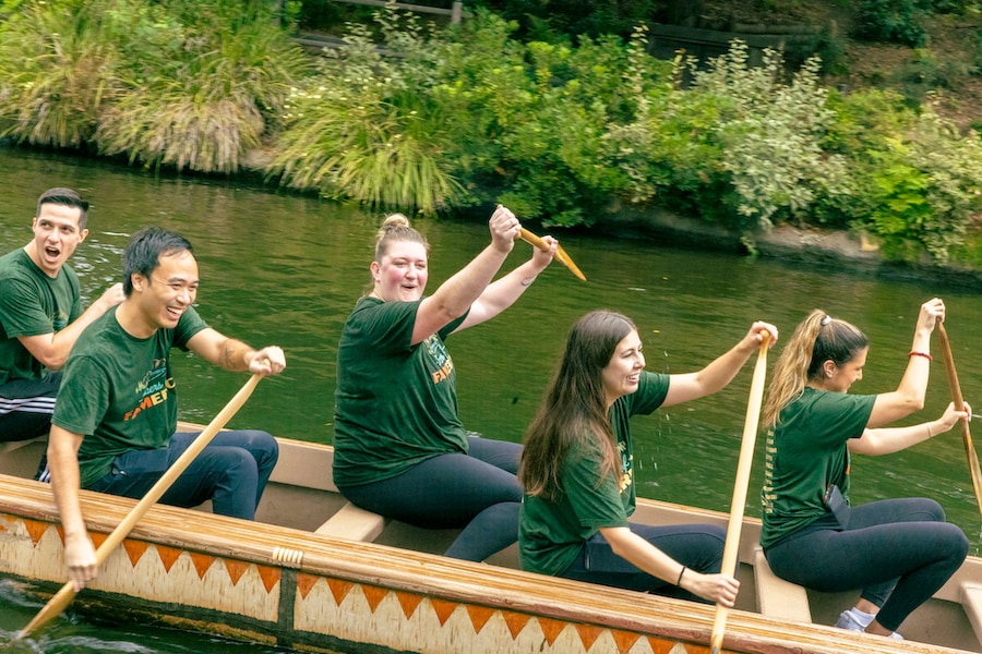 Members of the Rivers of FAMerica team smile as they paddle a canoe