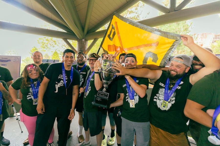 A winning team poses with their Canoe Races medals and trophy