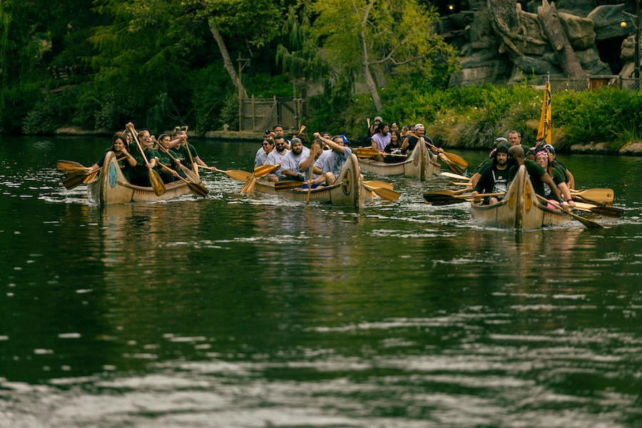 Four canoes are paddled down the Rivers of America