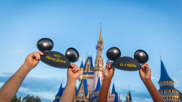Image of 2 Mickey ear hats in front of Cinderella Castle with embroidery of “2023 Disney Grants” and “$1.5 million.”