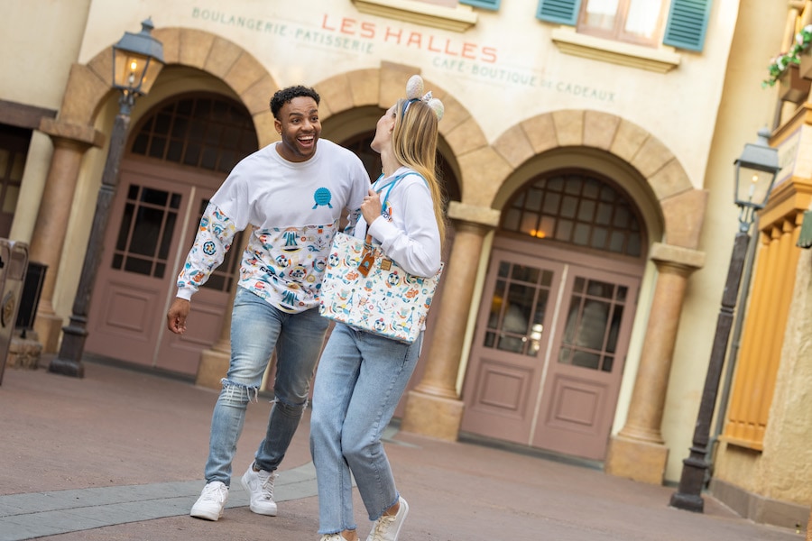 EPCOT Reimagined Zip Hoodie, featuring the EPCOT logo, with a matching Dooney & Bourke Tote Bag
