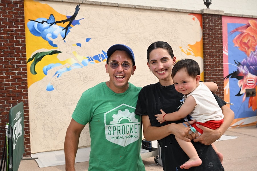 New mural at the Disney Springs Art Walk: A Canvas of Expression, created by Cuban American artists Katerina Santos and Juan Travieso (pictured with their son)