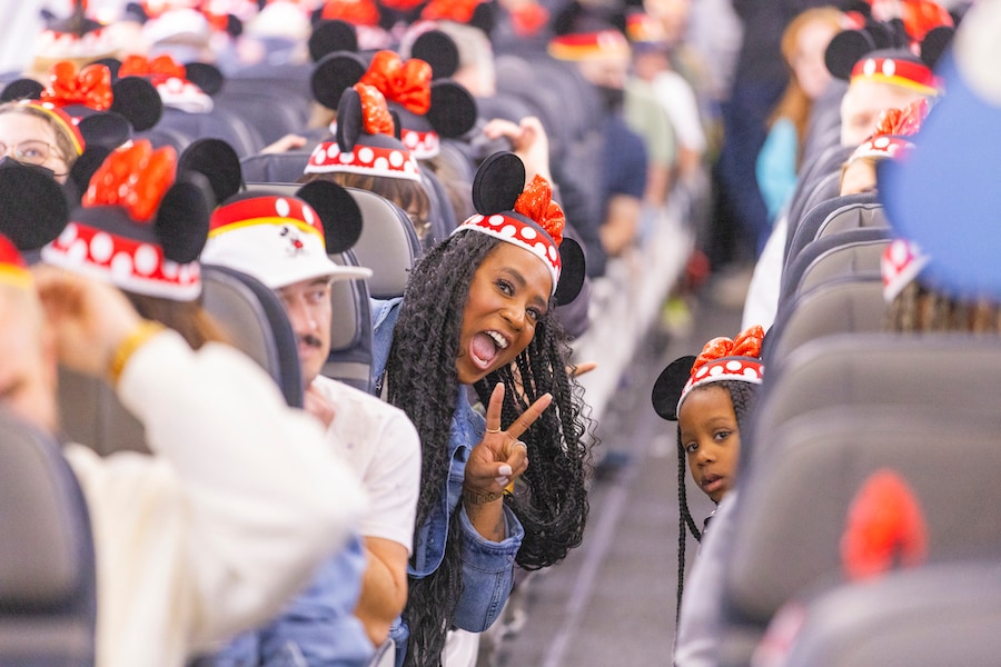 Guests on flight wearing Mickey Ears - Alaska Airlines Reveals Its New Disneyland Resort-Themed Plane “Mickey’s Toontown Express”