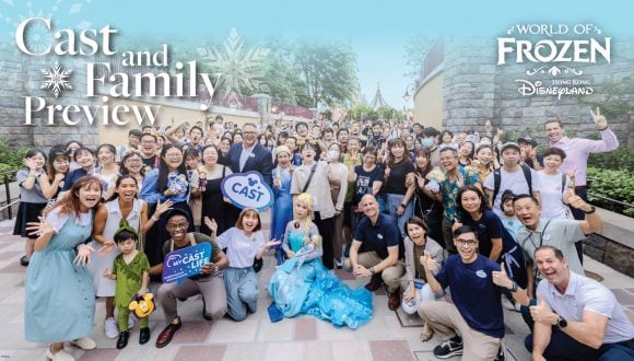 A group of cast members posing at the entrance to World of Frozen in Hong Kong Disneyland