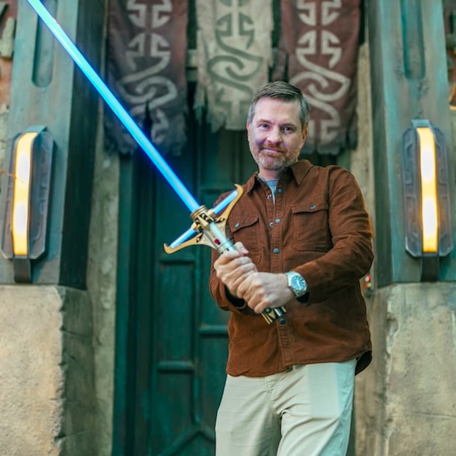 Charles Soule holding the new Stellan Gios Legacy LIGHTSABER Hilt from Star Wars: The High Republic at Star Wars: Galaxy's Edge at Disneyland Resort