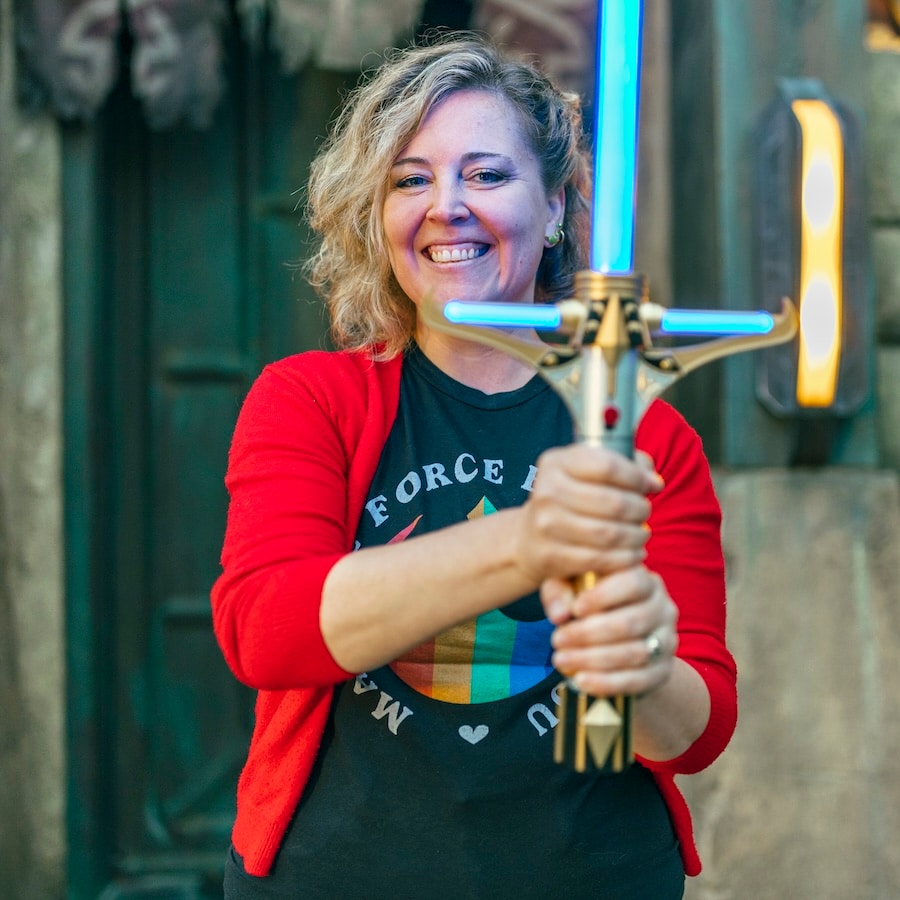 Tessa Gratton holding the new Stellan Gios Legacy LIGHTSABER Hilt from Star Wars: The High Republic at Star Wars: Galaxy's Edge at Disneyland Resort