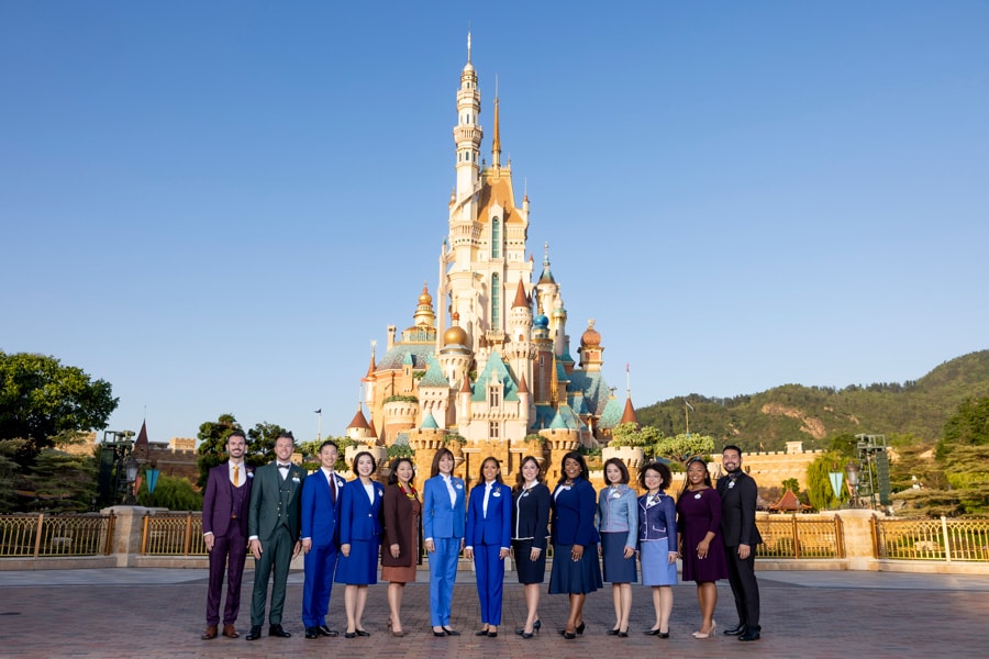 The Disney Ambassadors pose together in front of the Castle of Magical Dreams
