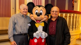 Cast members Louie and George pose with Mickey Mouse