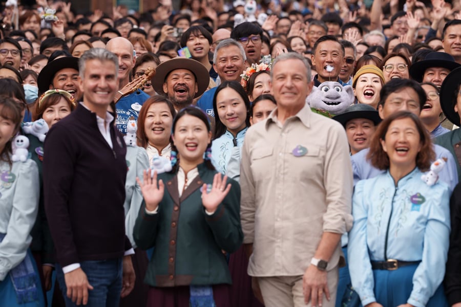 Mossie the talking baby troll featured in cast member photo featuring Bob Iger and Josh D'Amaro at the World of Frozen Grand Opening Ceremony at Hong Kong Disneyland