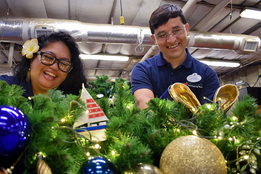 Cast members prepare holiday decorations