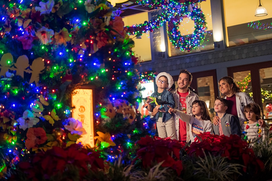Family observes Christmas tree at Disney Springs