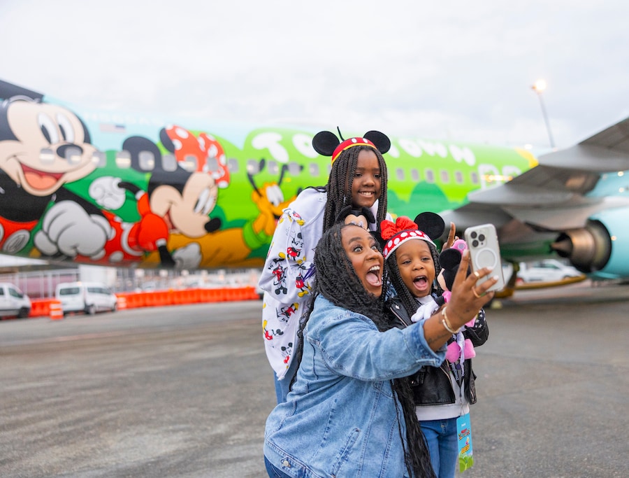 Guests take selfie with plane - Alaska Airlines Reveals Its New Disneyland Resort-Themed Plane “Mickey’s Toontown Express”