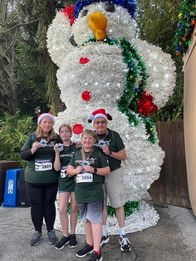 Cast member Darlene with her family during the 2022 Be Well...Cast Member, Friends & Family Holiday 5K