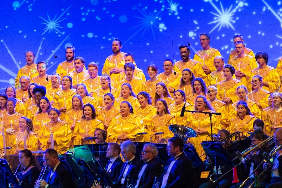 Chior members in the EPCOT Candlelight Processional during the EPCOT Festival of the Holidays