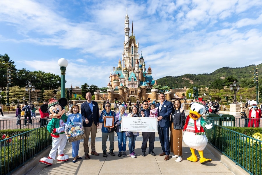 The Chen family with Michael Moriarty, Managing Director, Hong Kong Disneyland Resort, Mickey Mouse and Donald Duck in front of the Castle of Magical Dreams during a surprise moment when they were named the 100 millionth guest at Hong Kong Disneyland