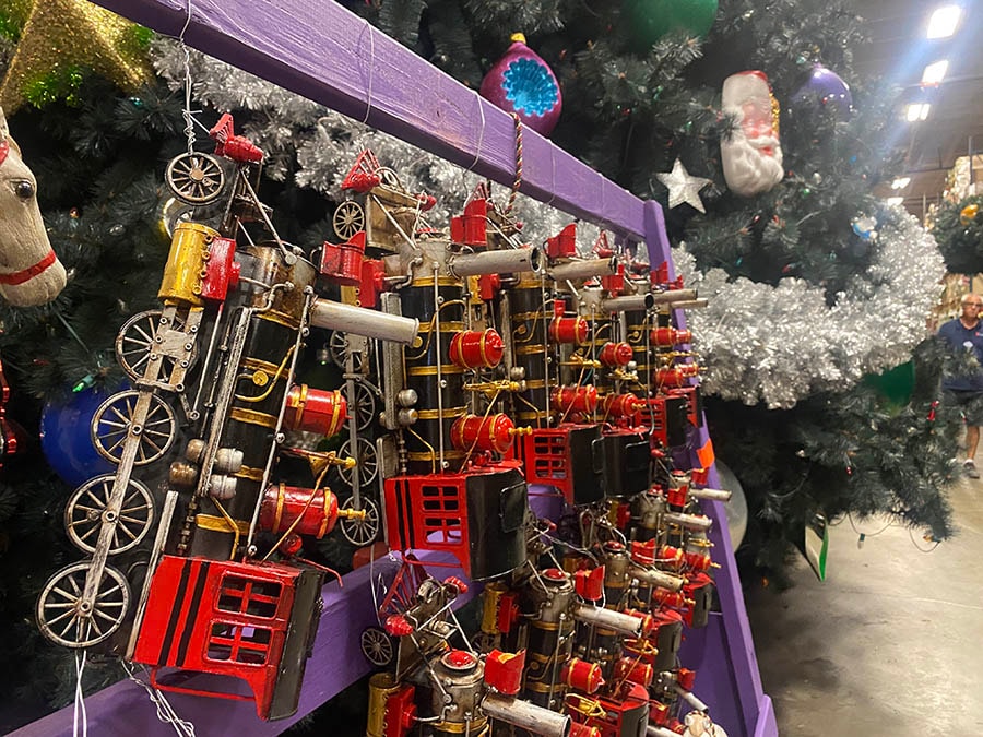 A set of train engine Christmas ornaments inside the Holiday Services warehouse