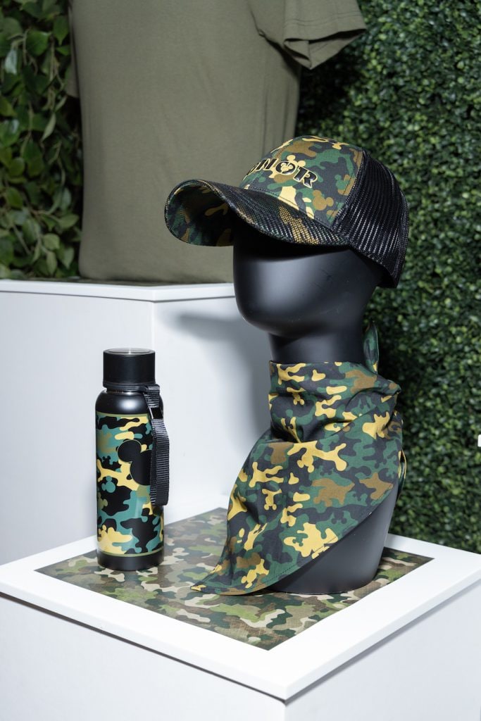 Mannequin wearing camouflage gear with a water bottle 