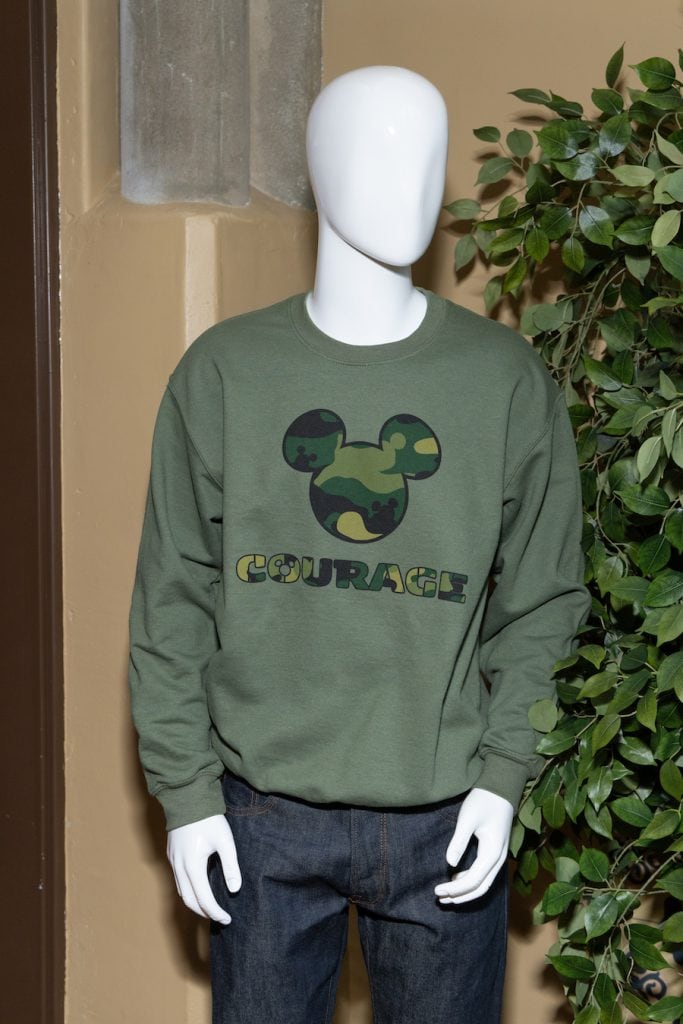Mannequin wearing green pull over sweatshirt with Camouflage Mickey