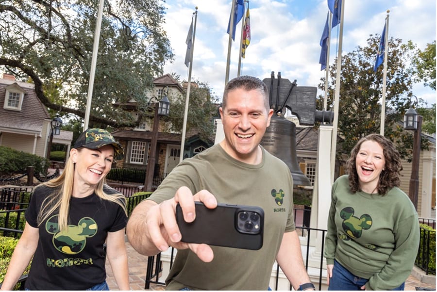Group photo with camouflage shirts in front of Liberty Bell at Disney's Magic Kingdom 