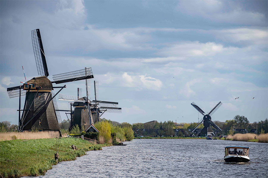 Windmills next to a river