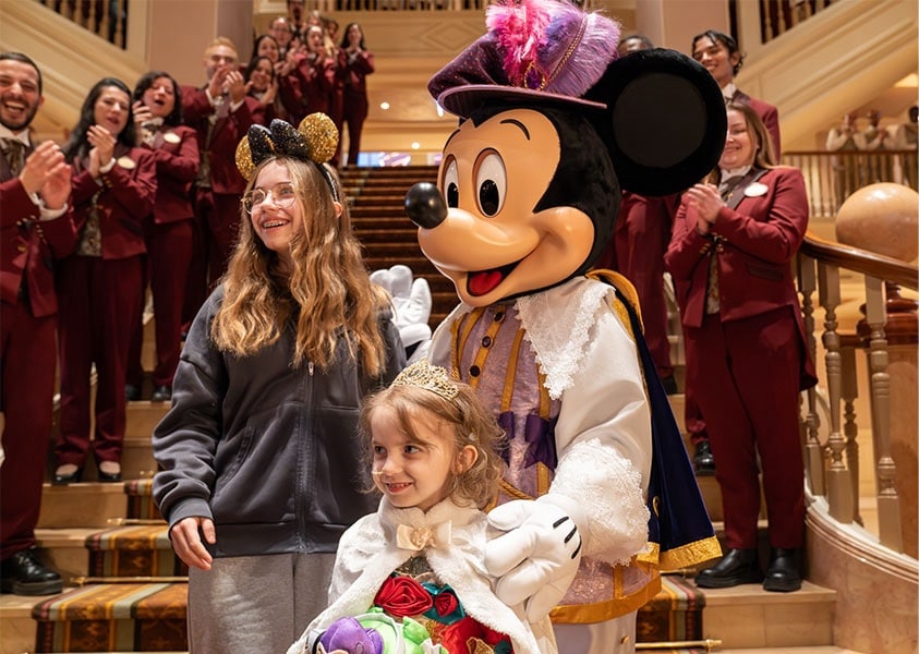 Make-A-Wish kid Marie with Mickey Mouse at the opening of Disneyland Hotel at Disneyland Paris
