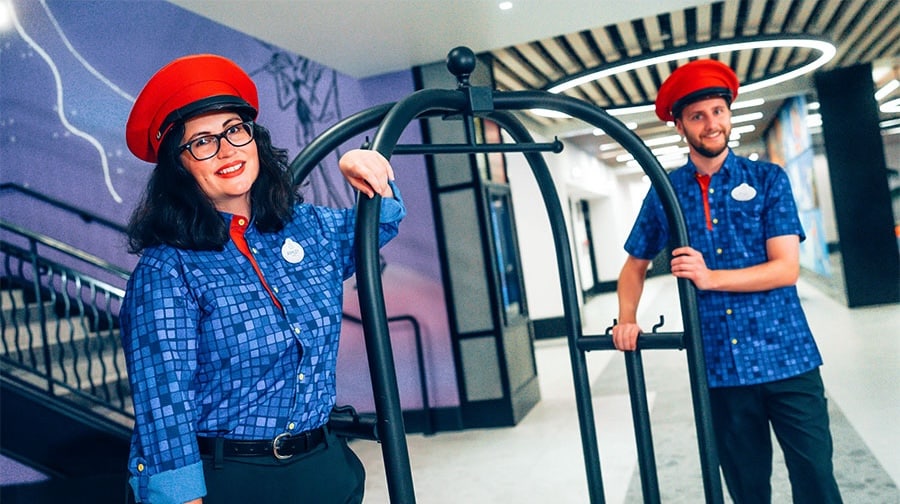 Bell service cast members in new costumes at the new Pixar Place Hotel at Disneyland Resort