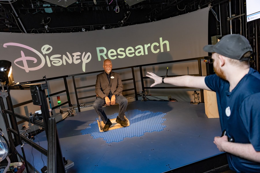 Image of Disney Imagineer Lanny Smoot posing for photo on new HoloTile floor invention.