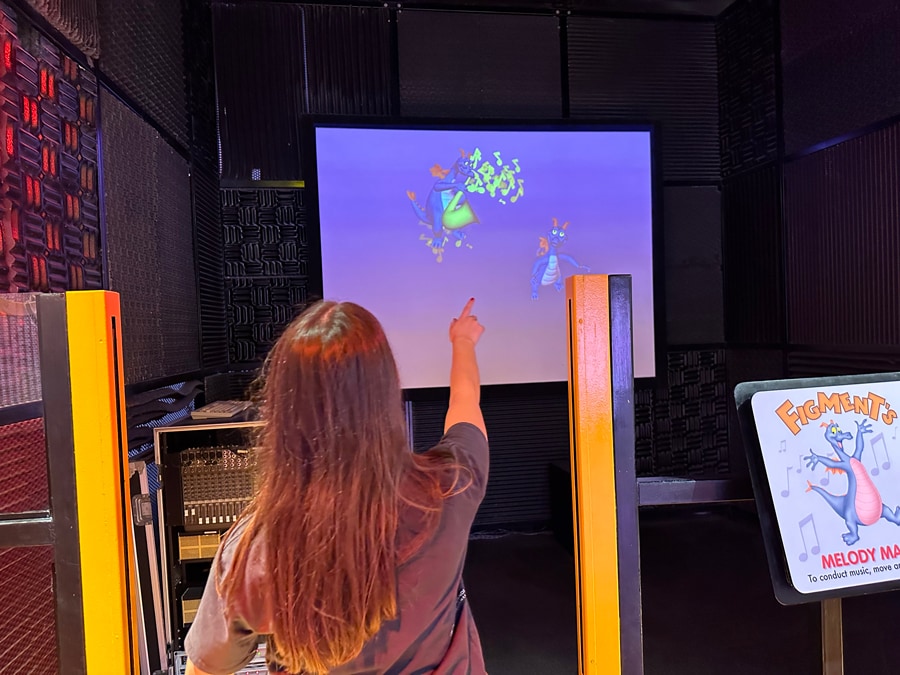 Image of guest interacting with Figment, music and sounds inside ImageWorks Lab at EPCOT