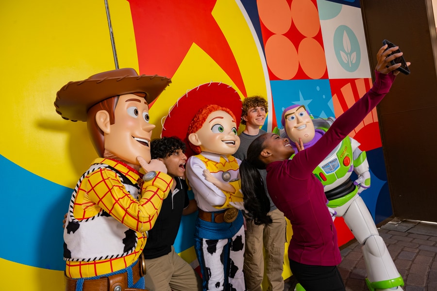 Image of Percy Jackson and the Olympians cast Walker Scobell (Percy), Leah Jeffries (Annabeth) and Aryan Simhadri (Grover Underwood) meeting Buzz and Woody at Toy Story Land at Walt Disney World.