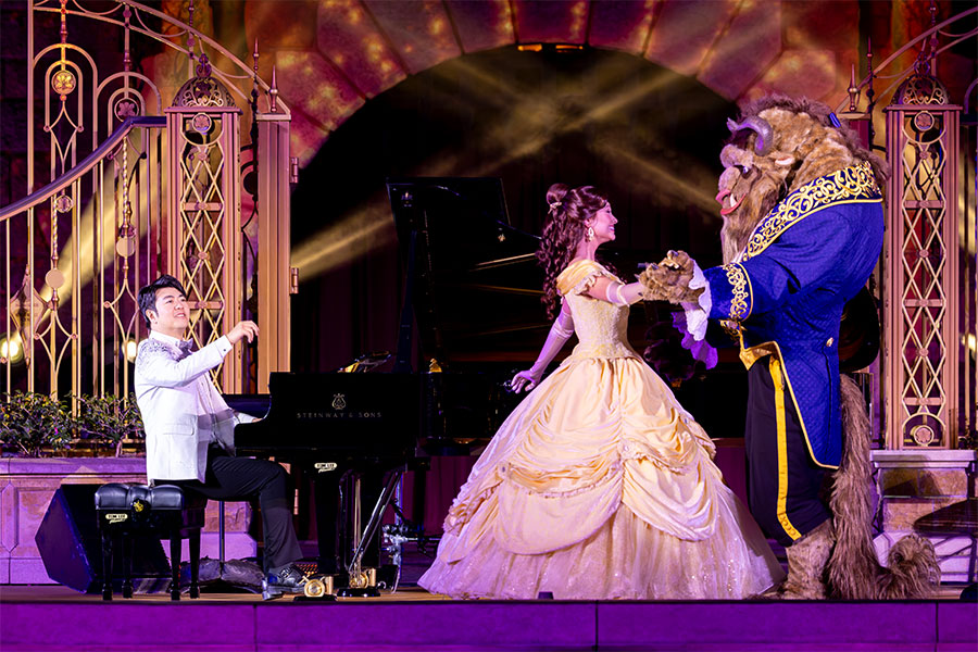 Pianist Lang Lang with Belle and Beast in front of Castle of Magical Dreams at Hong Kong Disneyland