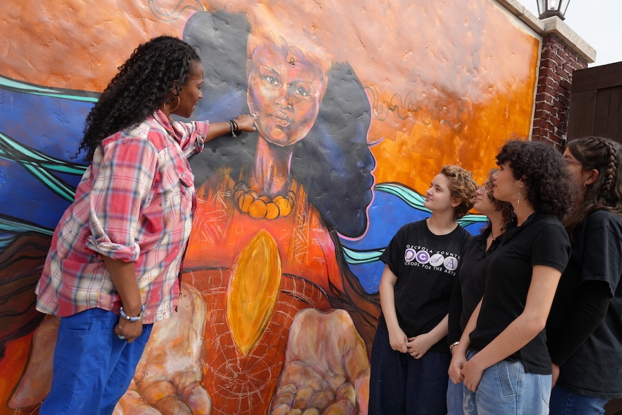 Image of art at Disney Springs at Walt Disney World Resort, artist with mural and students