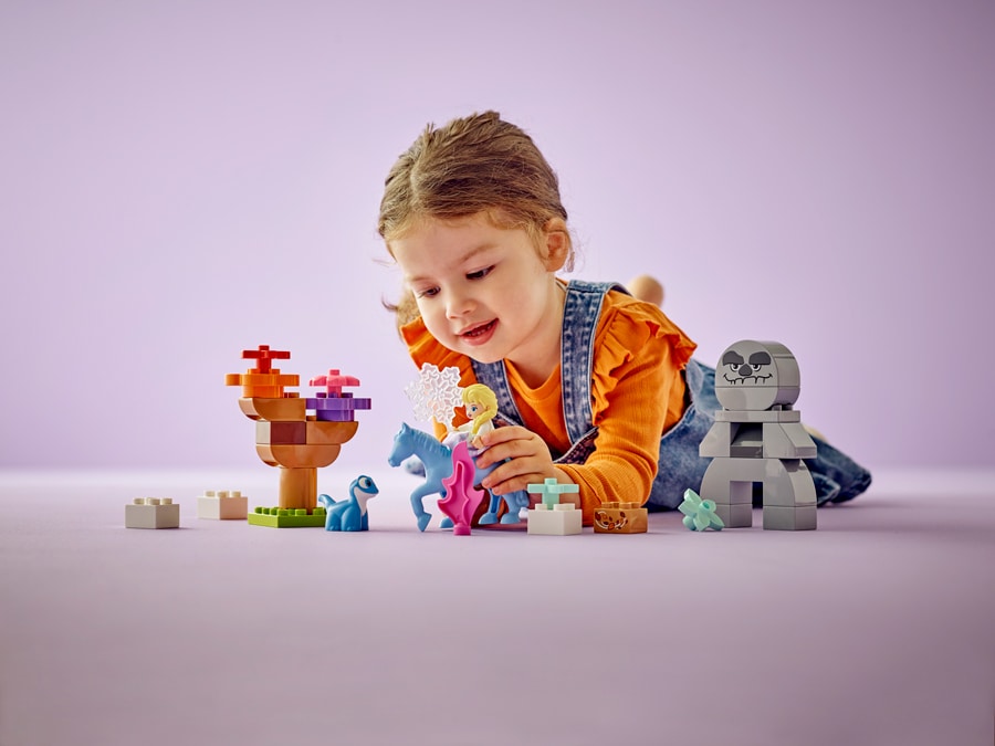 Child playing with a LEGO DUPLO Elsa and Bruni in the Enchanted Forest building set