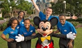 Disney Dreamers pose with Mickey Mouse in front of Cinderella Castle at Walt Disney World Resort