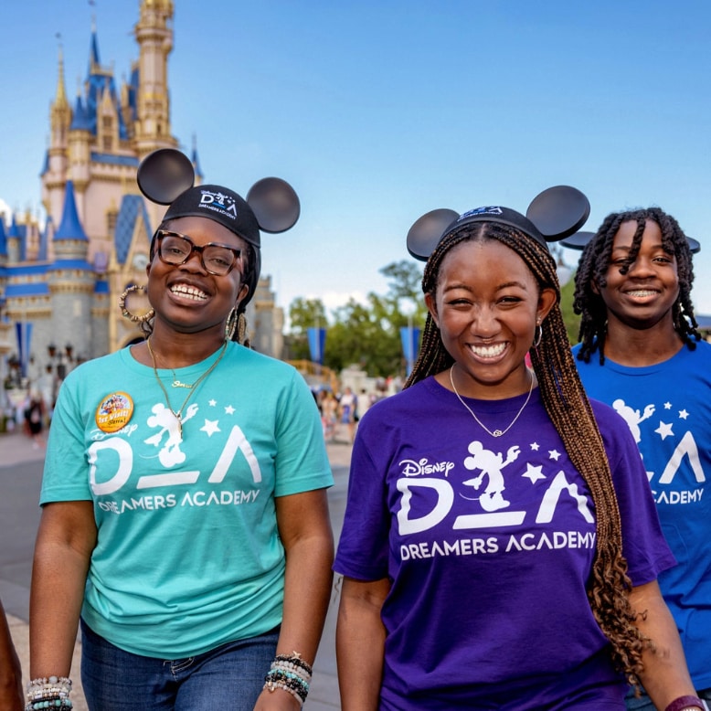 A group of smiling teenagers wearing Disney Dreamers Academy T shirts