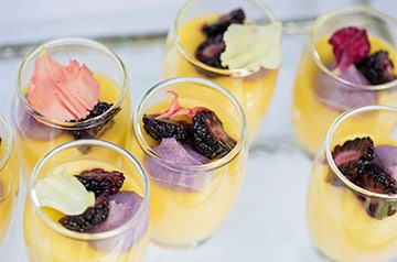 Glasses filled with drinks and topped with fruit