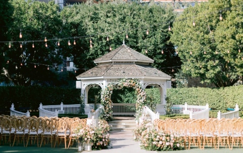 Many chairs face a gazebo in an outside courtyard Many chairs face a gazebo in an outside courtyard
