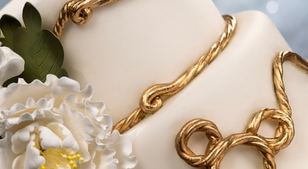 A fondant celebration cake with Mickey Mouse decorations