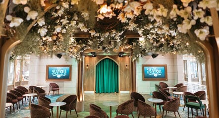 Flowers and leaves suspended over the seating area of The Bayou lounge