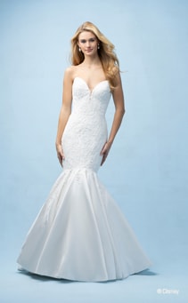  
A bride wearing an Ariel inspired mermaid gown featuring a sweetheart neckline