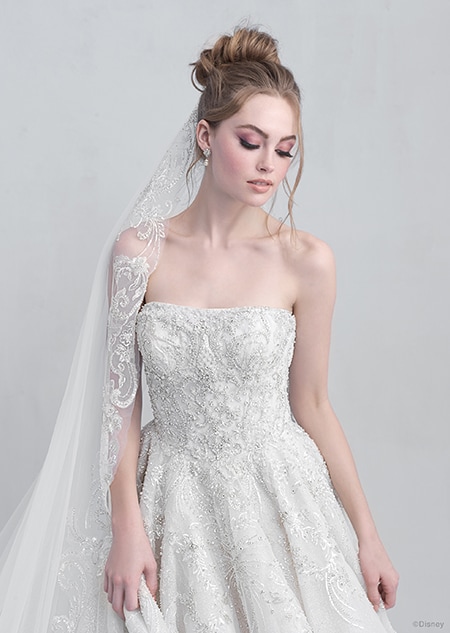 A front side view of a woman wearing the Cinderella wedding gown from the 2021 Disney Fairy Tale Weddings Platinum Collection