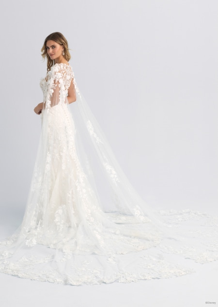 A wedding dress with a long and lacy cape inspired by Aurora from Sleeping Beauty