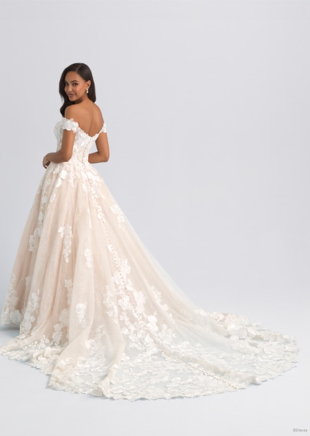 The back of an off the shoulder and lacy wedding dress featuring a long train inspired by Snow White The back of an off the shoulder and lacy wedding dress featuring a long train inspired by Snow White