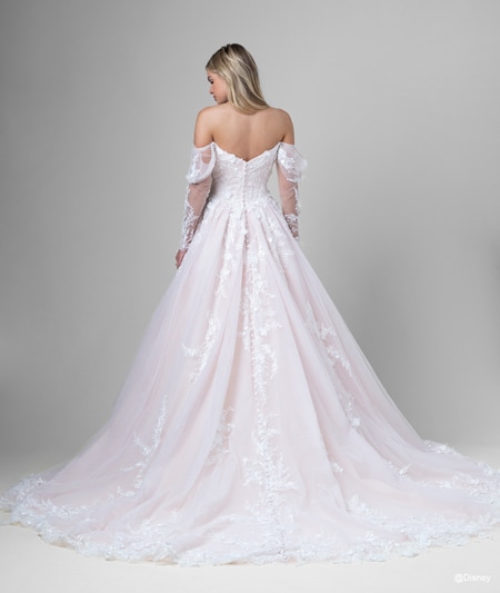 The back of a bride wearing an Aurora inspired A line gown featuring off the shoulder sleeves and lace detail The back of a bride wearing an Aurora inspired A line gown featuring off the shoulder sleeves and lace detail