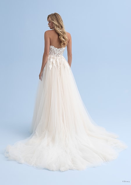 The back of an off the shoulder wedding dress worn by a bride with long hair