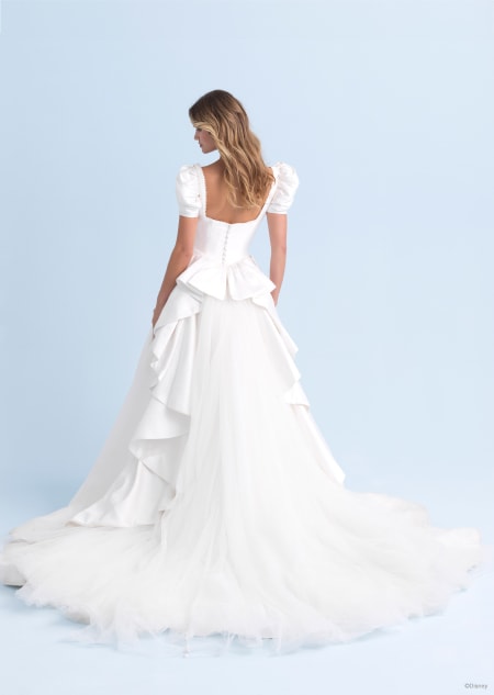 The back of a wedding dress with balloon sleeves and a long trail inspired by Cinderella
