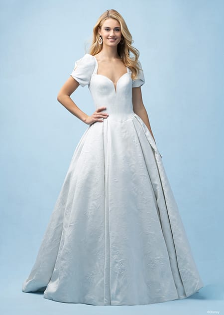 The front of a bride wearing a Cinderella inspired ball gown featuring a sweetheart neckline with cap sleeves