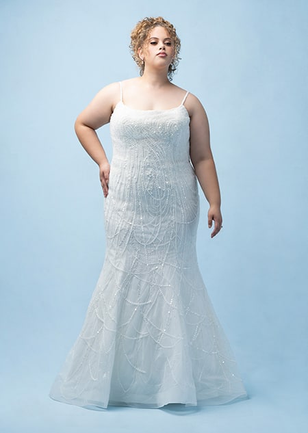 The front of a bride wearing a Tiana inspired sheath gown featuring beading, sequins and a spaghetti strap neckline