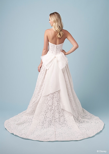 The back of a bride wearing a strapless Snow White inspired A line gown featuring a bow on the bustle