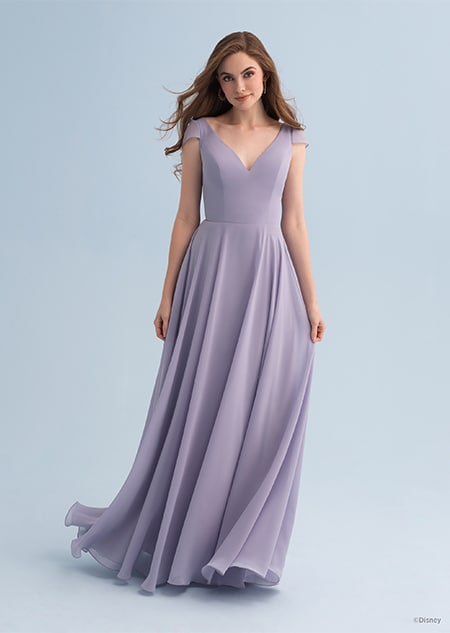 A woman wearing a Rapunzel themed bridesmaid dress with a V neckline and cap sleeves