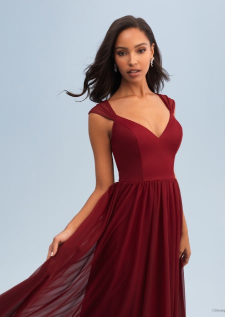 A woman wearing a Snow White themed bridesmaid dress with a Queen Anne neckline